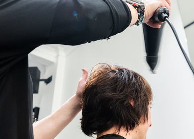 Hairdresser blowdrying a client's hair at Moscato Hair, West Melbourne, VIC, AU.