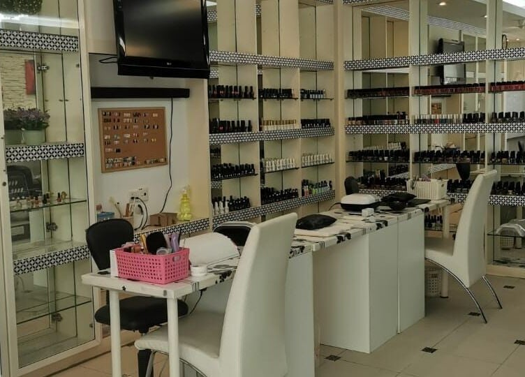 Chic interior of Golden Beauty Nail Bar in Petaling Jaya, Selangor, MY showcasing nail polish collection.