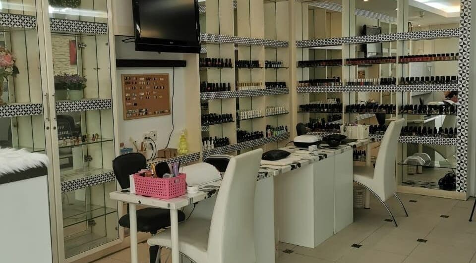 Chic interior of Golden Beauty Nail Bar in Petaling Jaya, Selangor, MY showcasing nail polish collection.