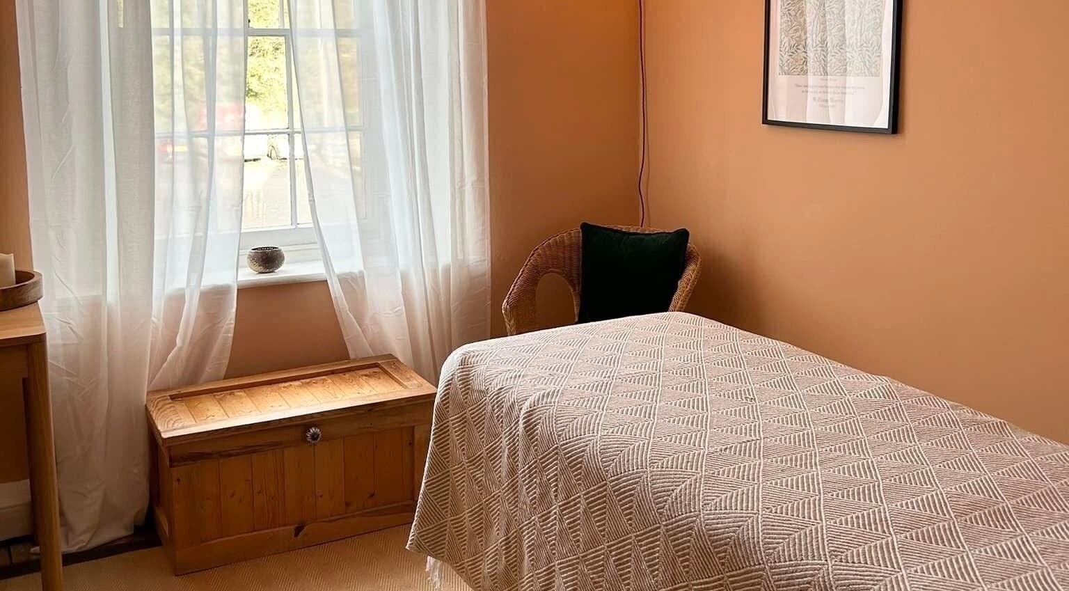 Relaxing room at Rewild Reflexology - Frome, featuring a cozy bed and soft lighting in Frome, England, GB.
