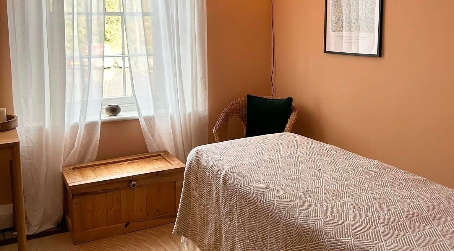 Relaxing room at Rewild Reflexology - Frome, featuring a cozy bed and soft lighting in Frome, England, GB.