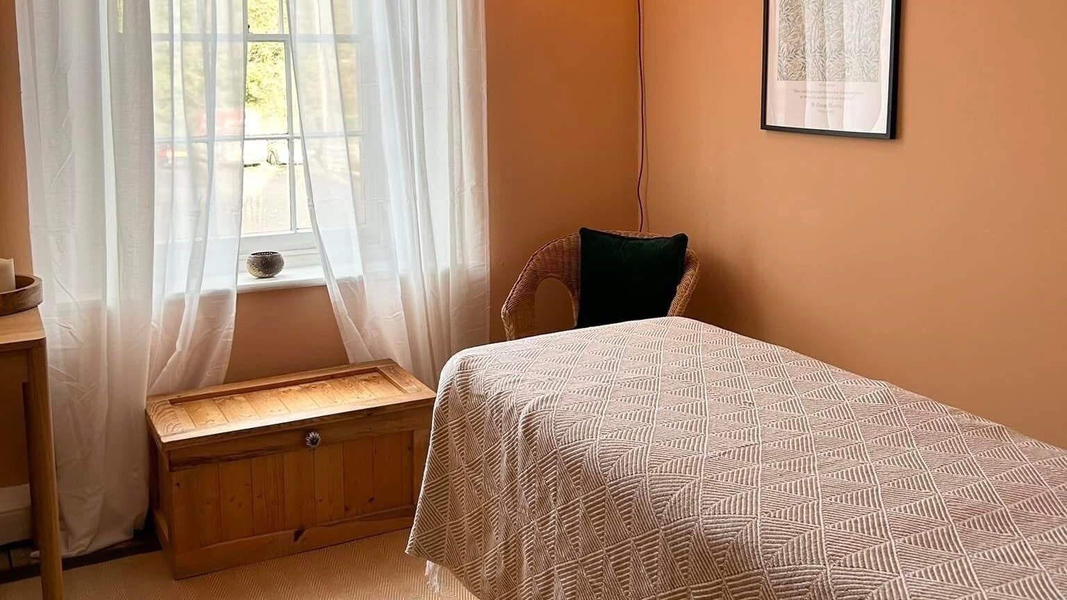 Relaxing room at Rewild Reflexology - Frome, featuring a cozy bed and soft lighting in Frome, England, GB.