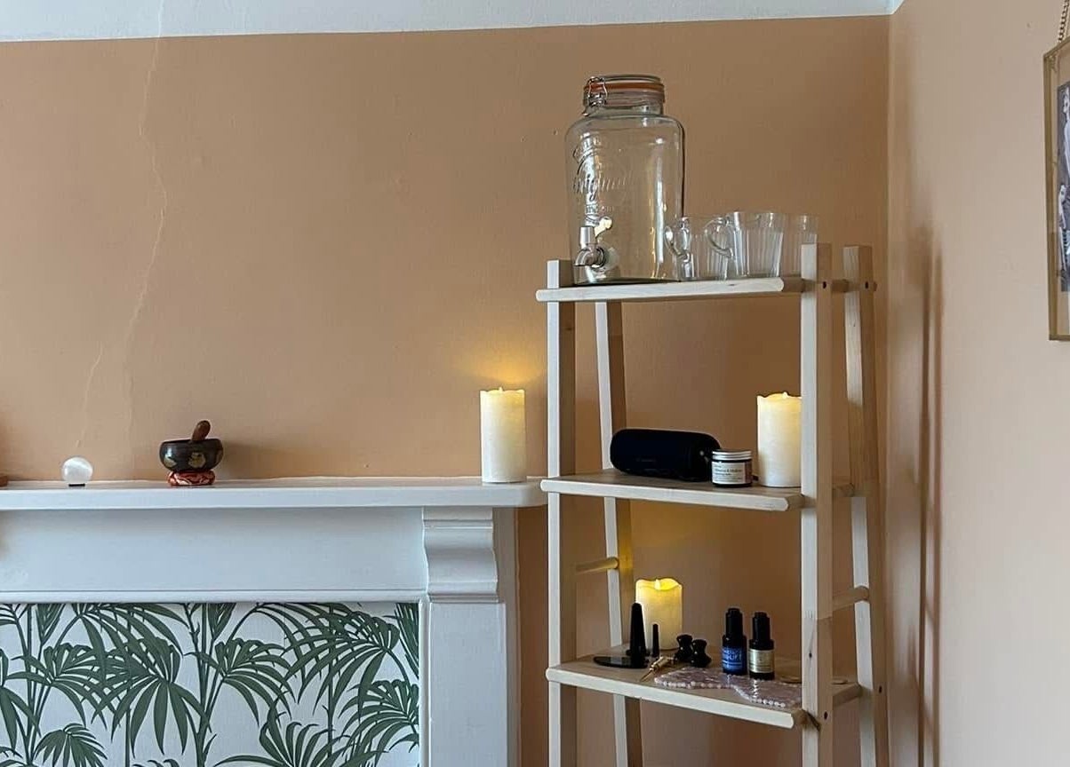 Cozy corner with candles and wellness items at Rewild Reflexology - Frome, in Frome, England, GB.