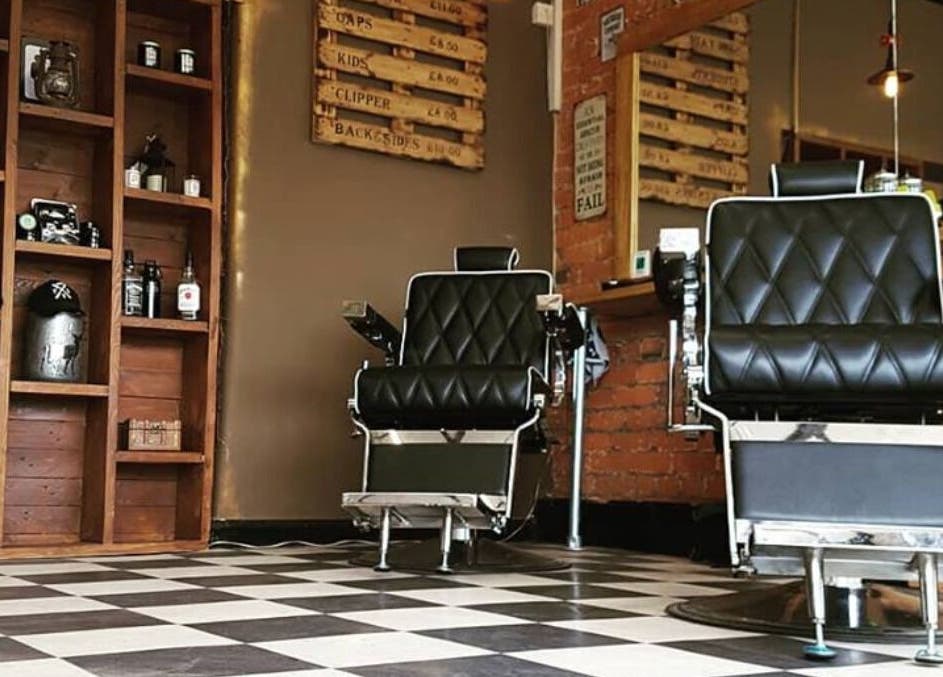 Prestige Barbers in Bebington, England, featuring classic chairs and rustic decor for a stylish grooming experience.