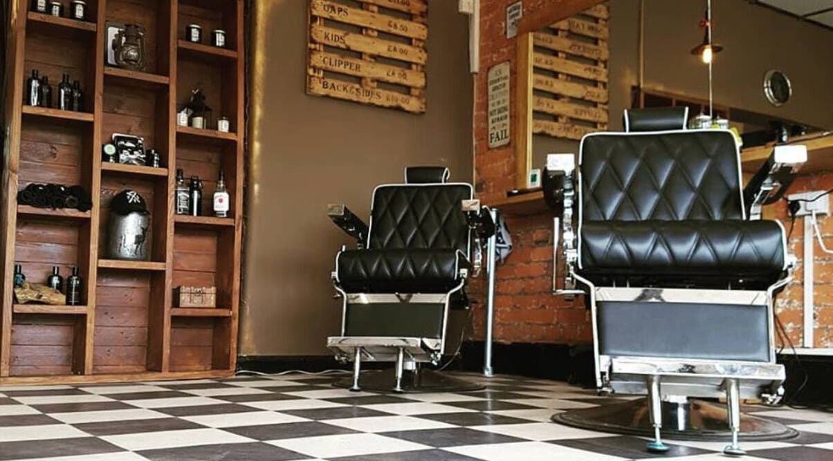 Prestige Barbers in Bebington, England, featuring classic chairs and rustic decor for a stylish grooming experience.