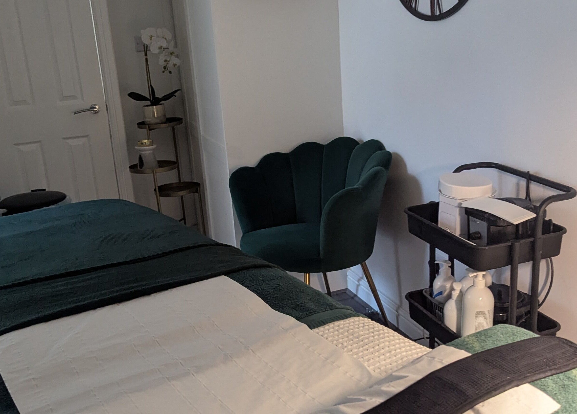 Elegant treatment room at Skinsense, Crawley, England, GB, featuring a plush chair and neatly organized supplies.
