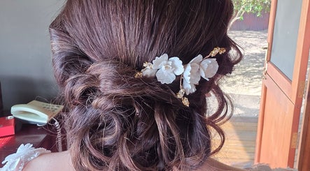 Intricate bridal hairstyle adorned with flowers at Hair Therapy Knysna, Knysna, Western Cape, ZA.