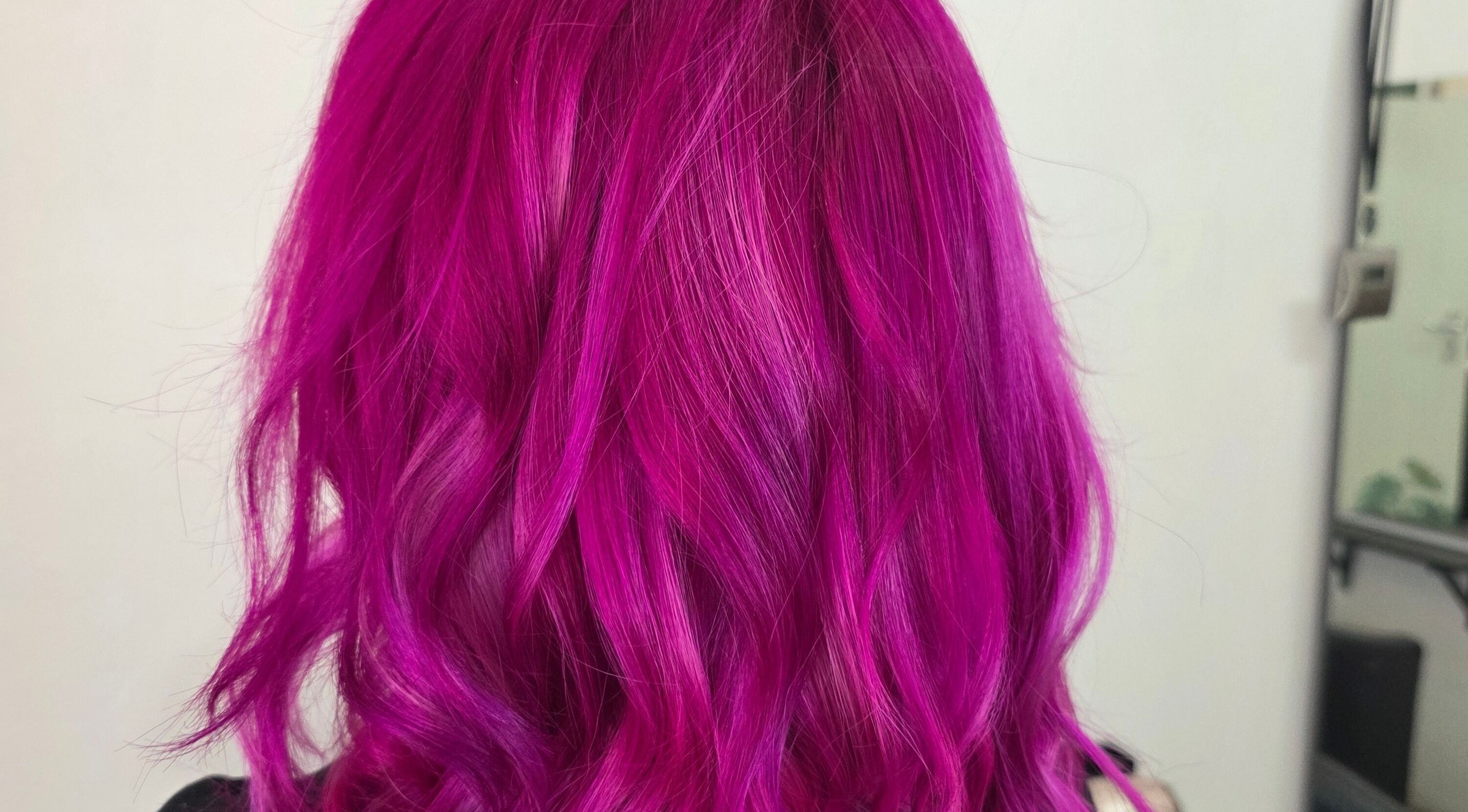 Magenta hair styling at Hair Therapy Knysna, Knysna, Western Cape, ZA; showcasing vibrant salon expertise.