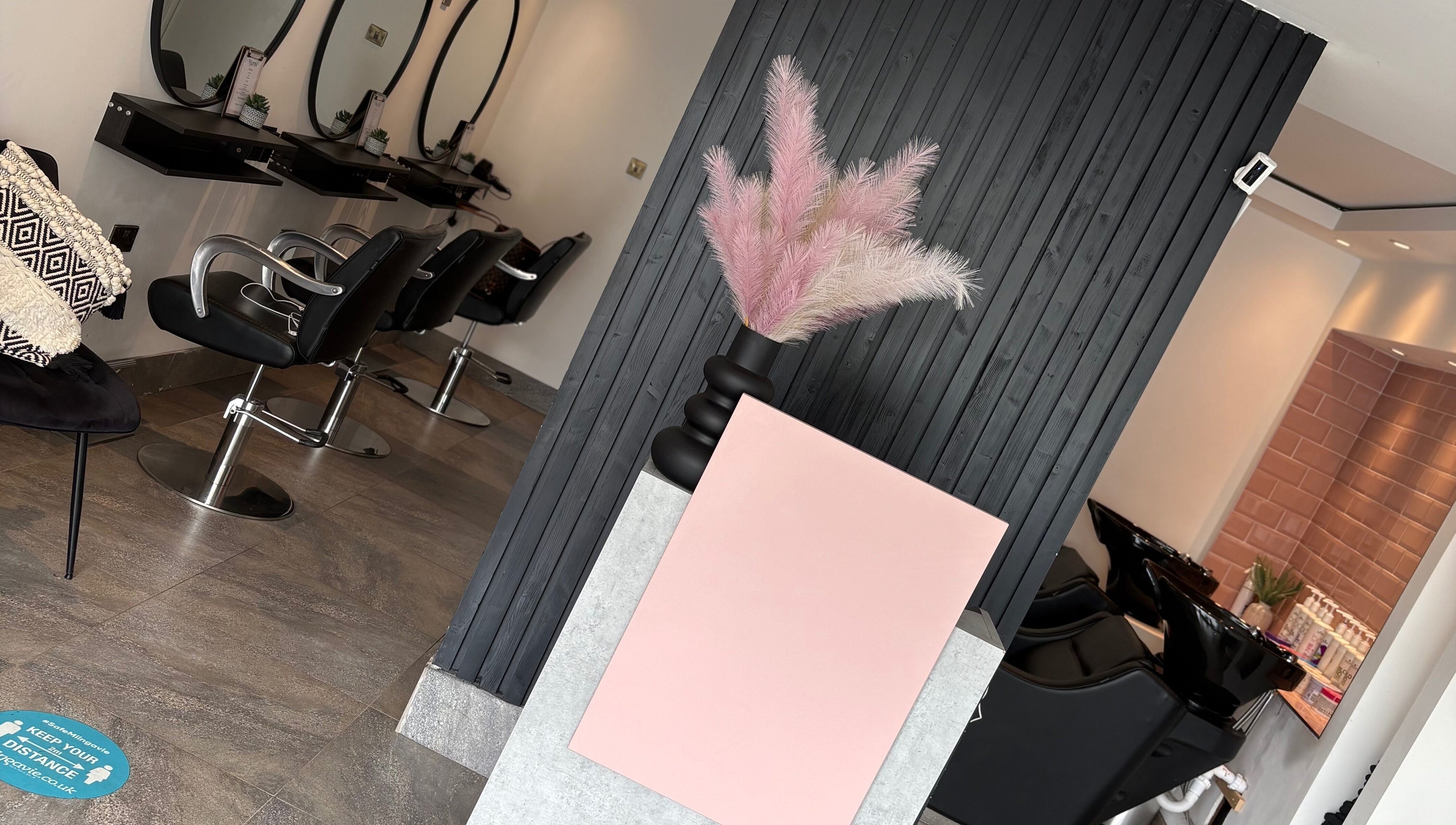 Stylish interior of Ego Hairdressing, Milngavie, Scotland, GB, featuring sleek seating and chic decor.