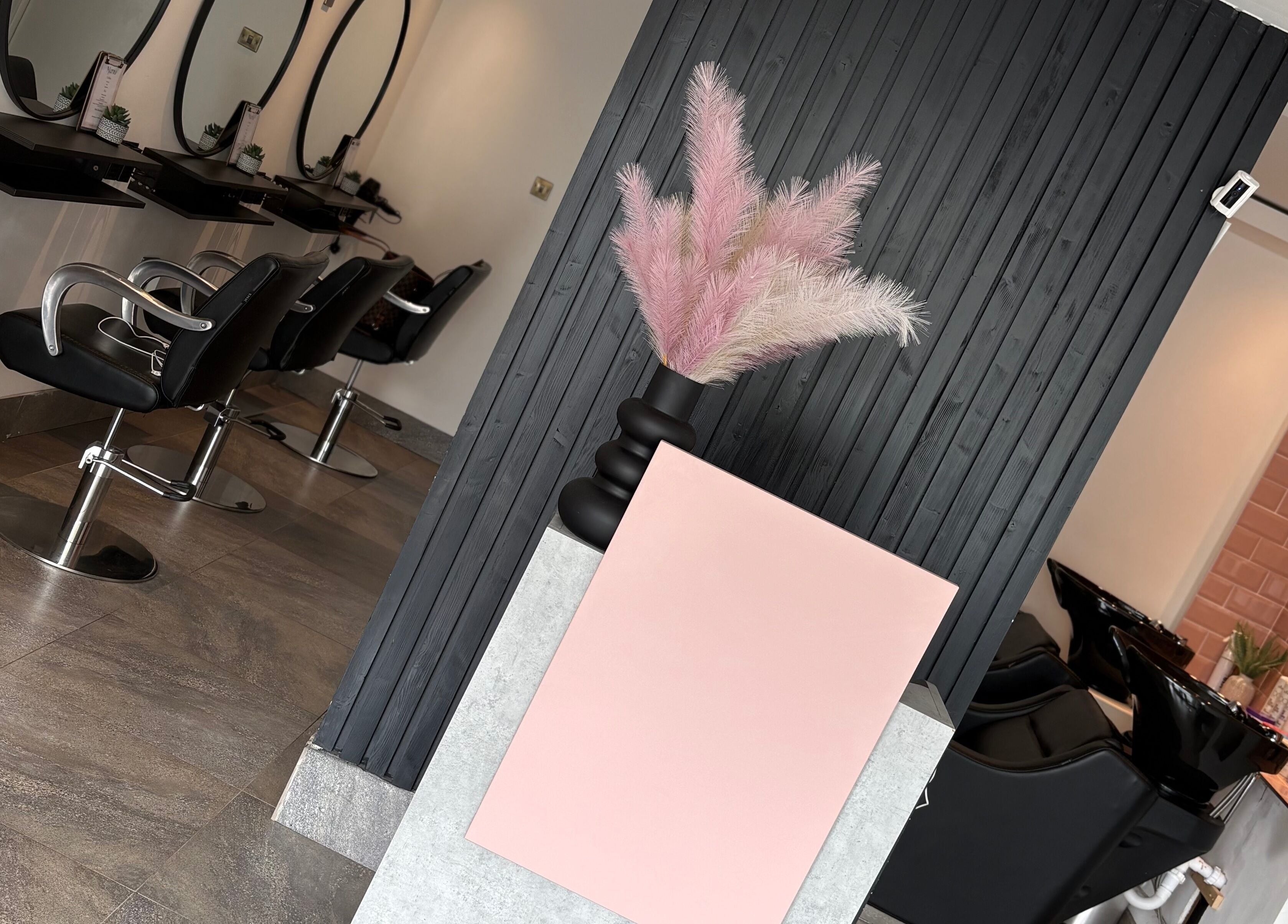 Stylish interior of Ego Hairdressing, Milngavie, Scotland, GB, featuring sleek seating and chic decor.
