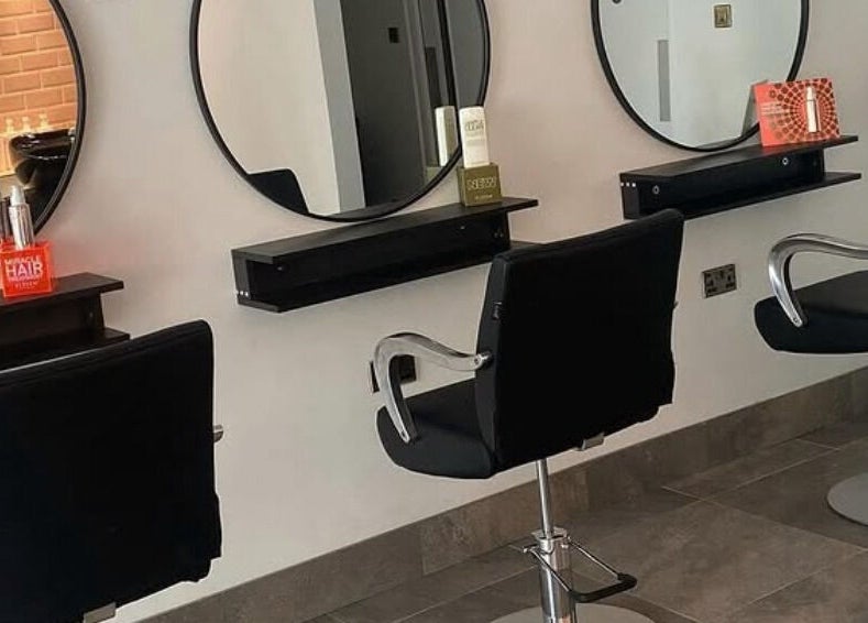 Modern styling chairs and mirrors at Ego Hairdressing, Milngavie, Scotland, GB, showcasing a sleek salon interior.