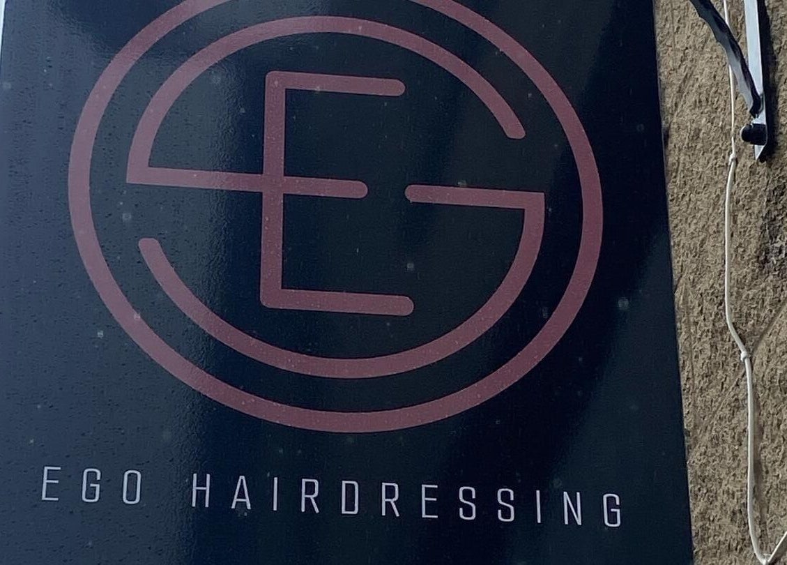Ego Hairdressing signboard at Milngavie, Scotland, GB, showcasing elegant logo design.