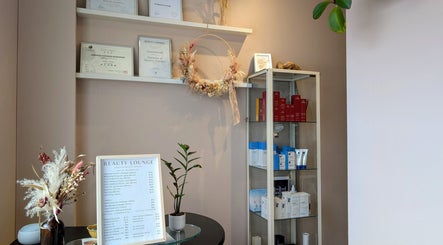 Elegant interior of JH Beauty Lounge in Neutral Bay, showcasing certificates and skincare products.