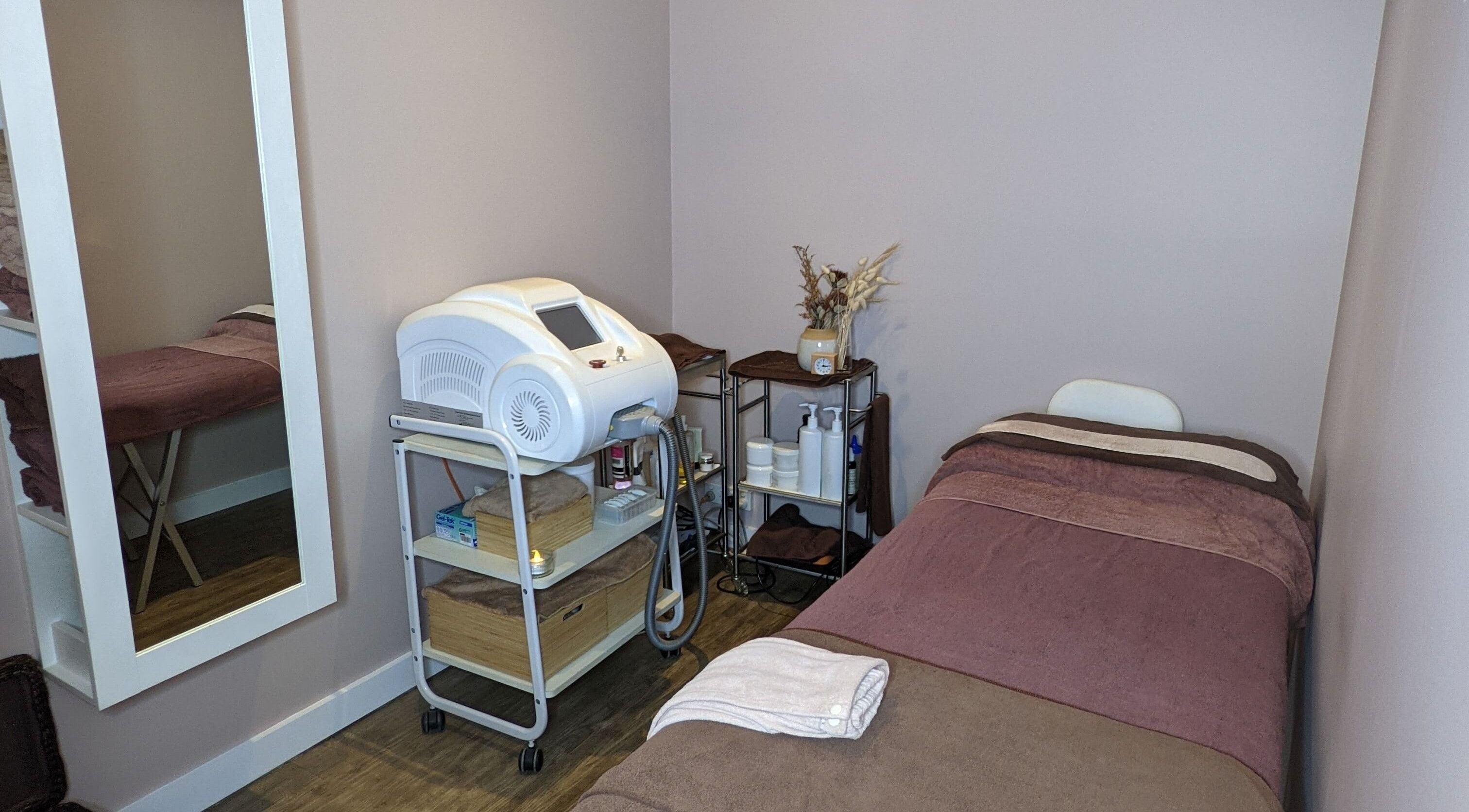 Relaxing treatment room at JH Beauty Lounge, Neutral Bay, New South Wales, AU with spa bed and equipment.