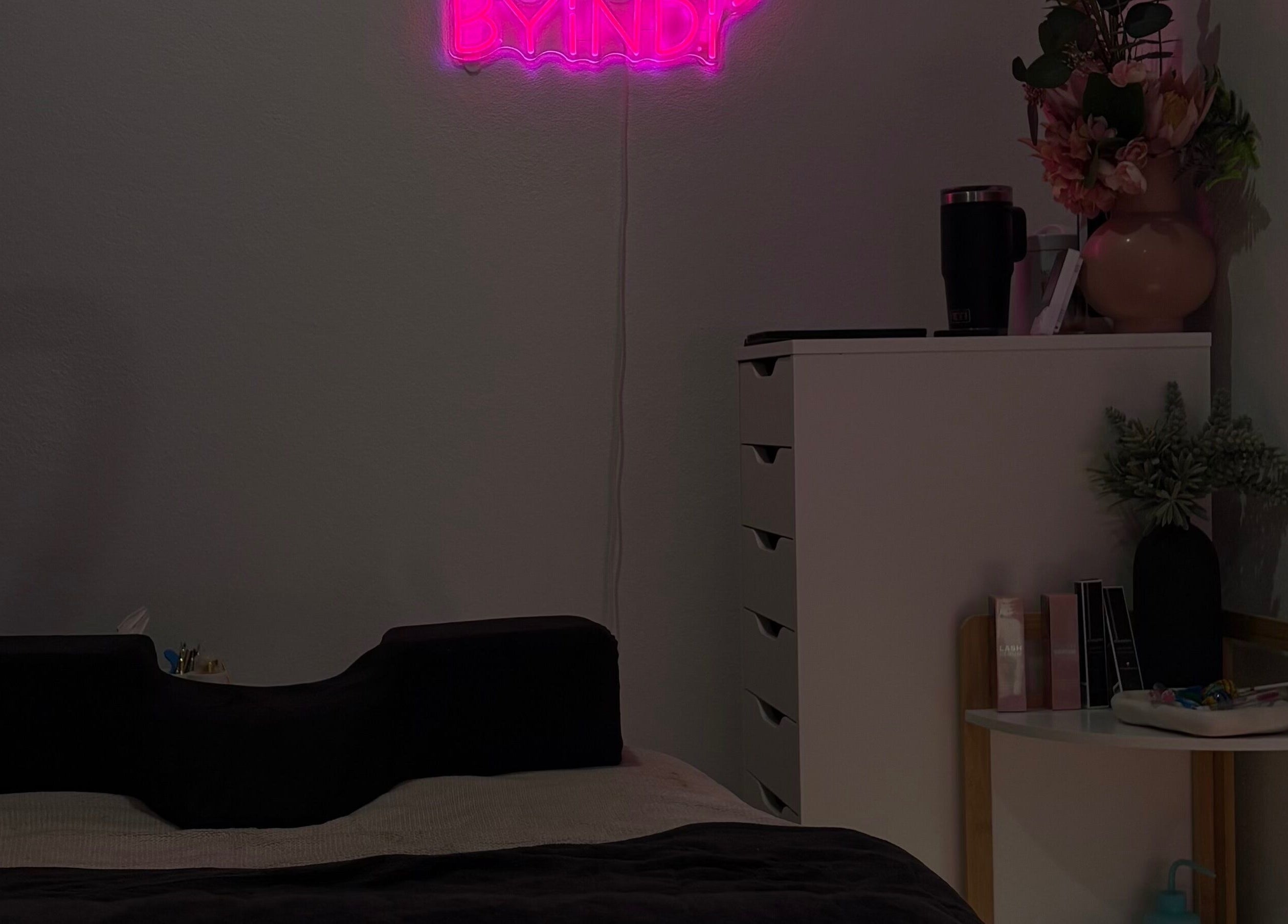 Relaxing beauty room at Beauty by Indi - Myaree, featuring neon decor and flowers, Myaree, Western Australia, AU.