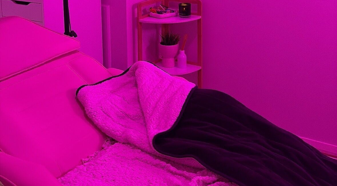 Relaxing treatment room at Beauty by Indi - Bertram, showcasing cozy pink lighting. Located in Bertram, Western Australia, AU.