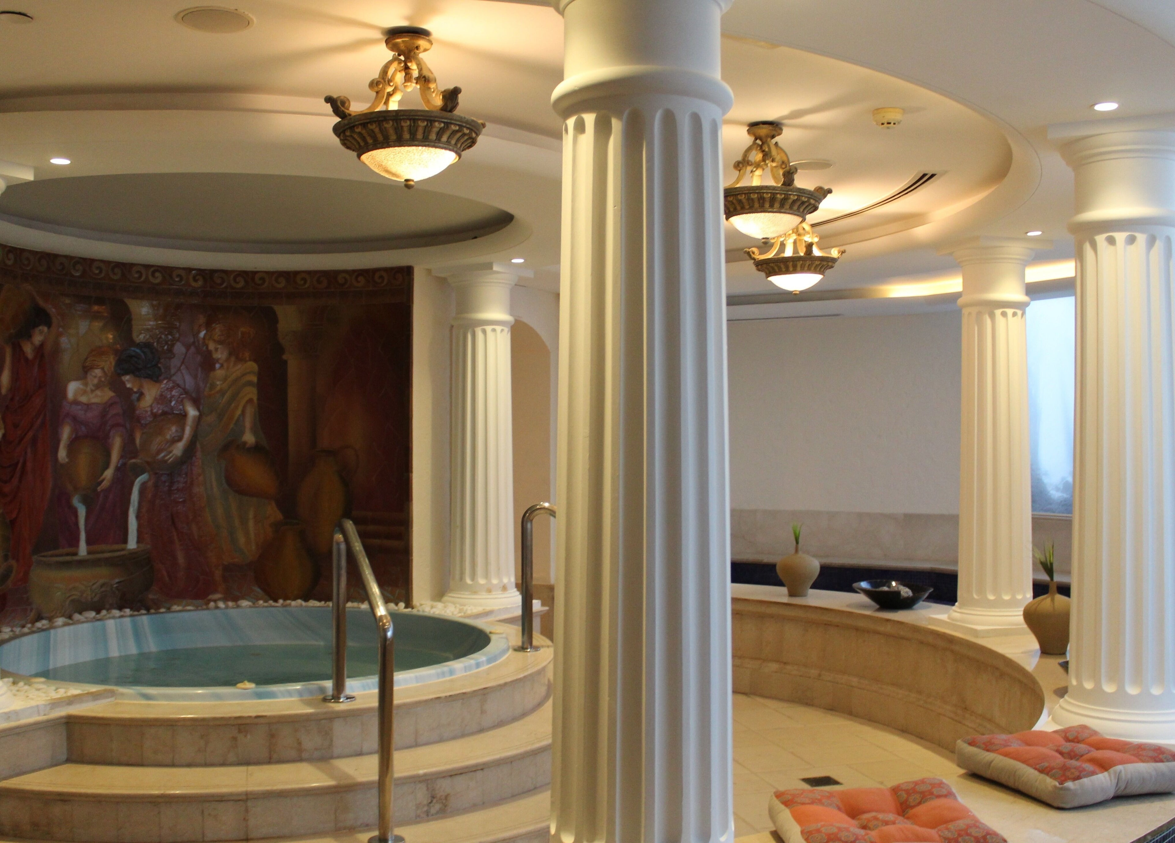 Luxurious Roman bath at Wellbeings Holistic Healing - Fairmont, Dubai, AE featuring elegant columns and spa ambiance.