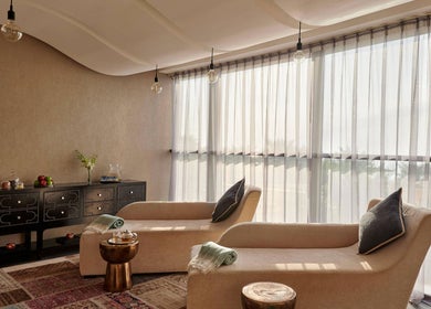 Comfortable lounge chairs at Wellbeings Holistic Healing, Fairmont, Ajman, AE, offering peaceful relaxation.