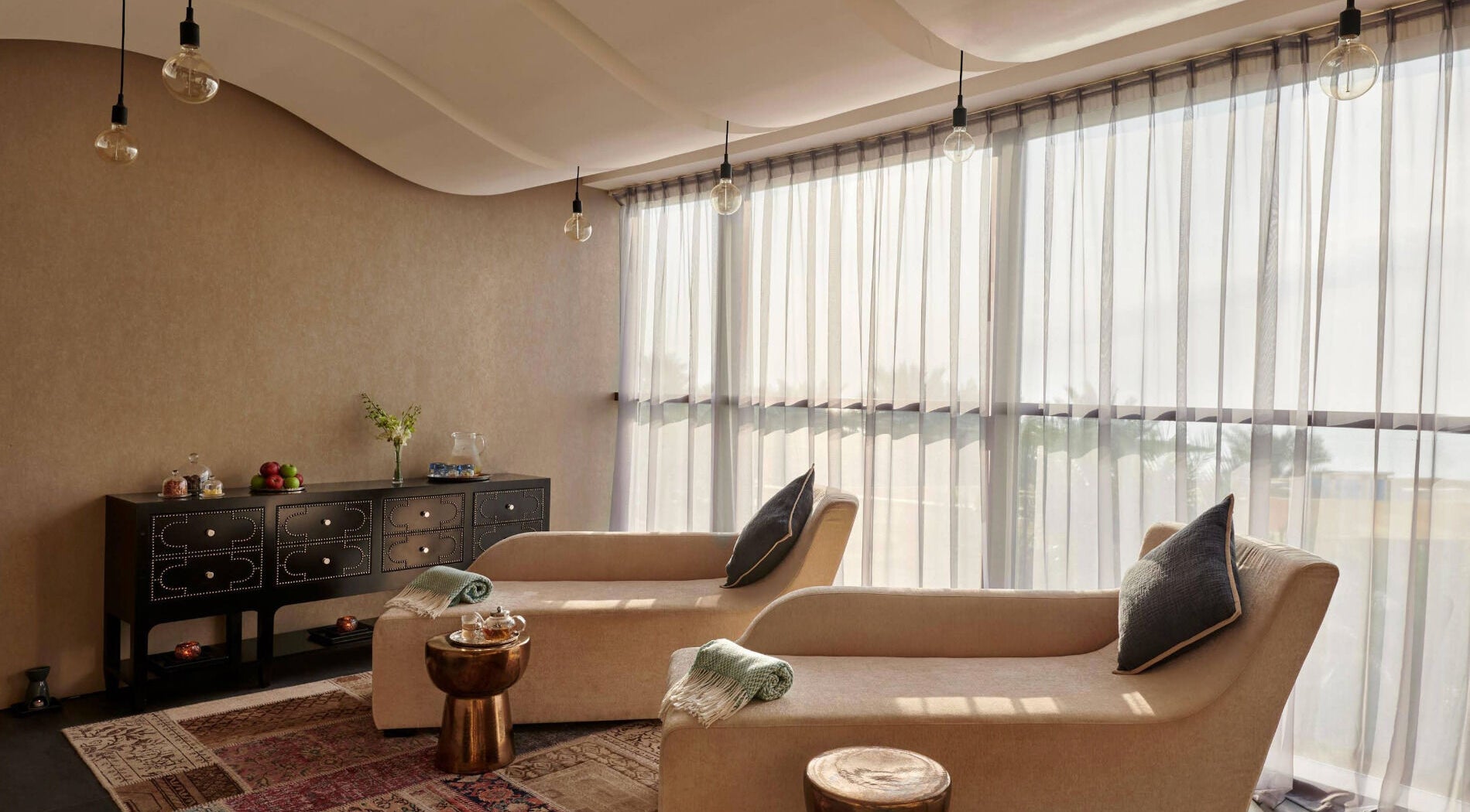 Comfortable lounge chairs at Wellbeings Holistic Healing, Fairmont, Ajman, AE, offering peaceful relaxation.