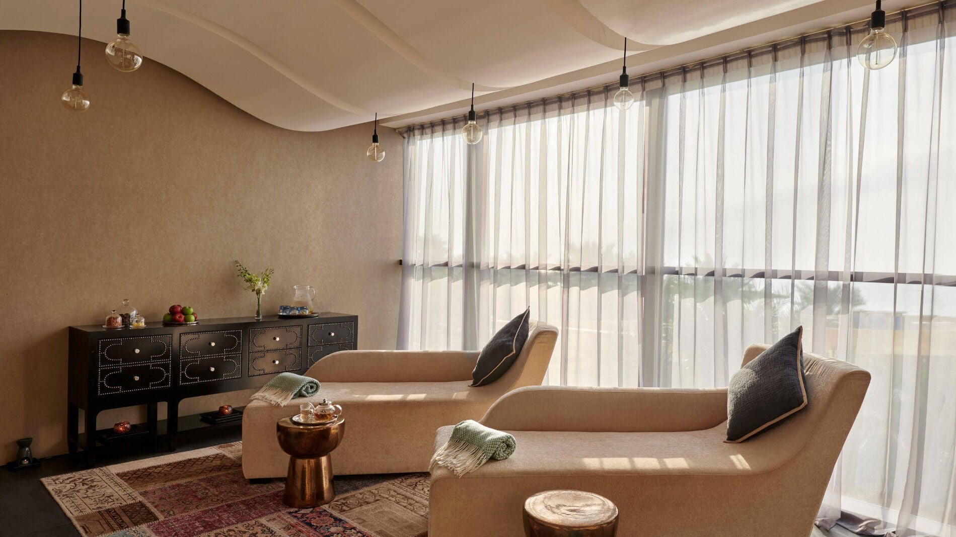 Comfortable lounge chairs at Wellbeings Holistic Healing, Fairmont, Ajman, AE, offering peaceful relaxation.