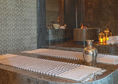 Luxurious spa interior at Wellbeings Holistic Healing, Fairmont, Ajman, featuring elegant stone decor. Ajman, AE.