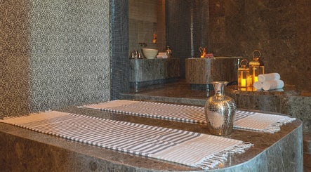Luxurious spa interior at Wellbeings Holistic Healing, Fairmont, Ajman, featuring elegant stone decor. Ajman, AE.