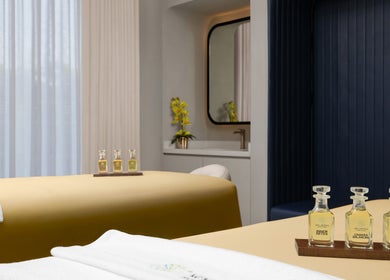 Relaxing treatment room at Wellbeings Holistic Healing, Hotel Indigo Dubai in Dubai, AE, featuring plush massage tables.