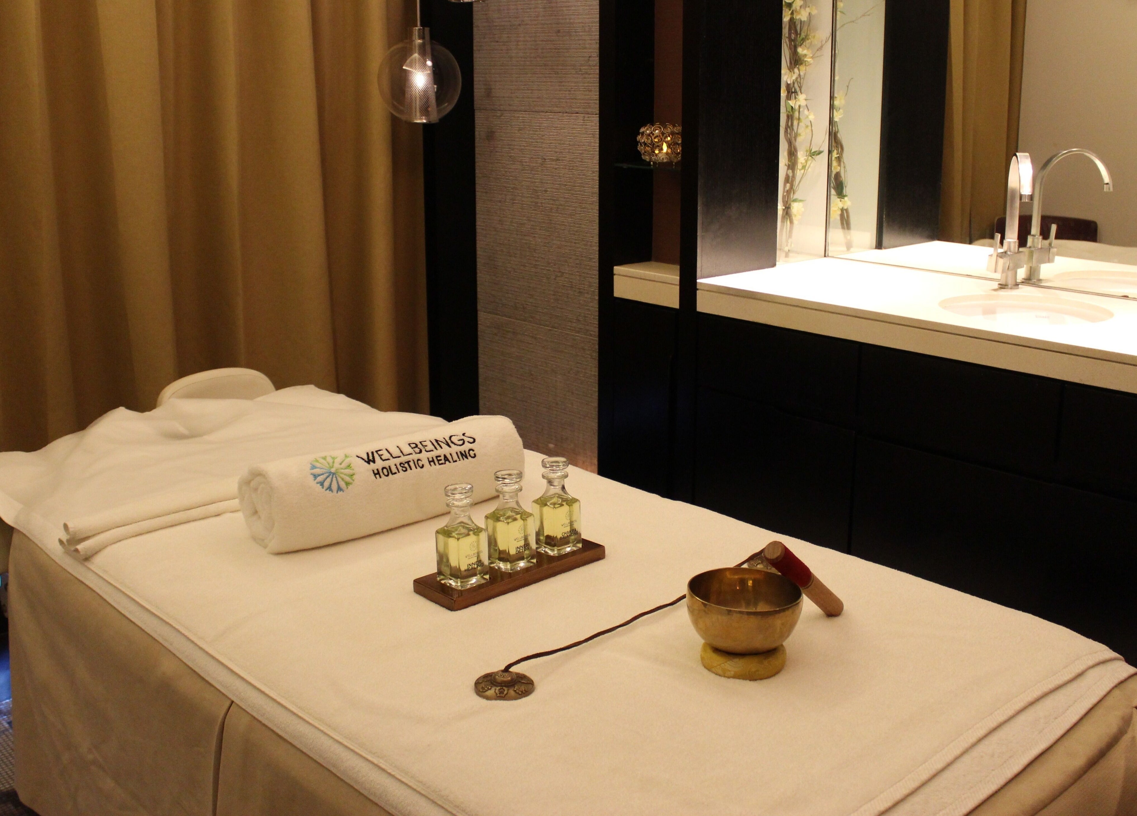 Relaxing massage room at Wellbeings Holistic Healing, Dubai, AE, featuring a treatment table and calming decor.