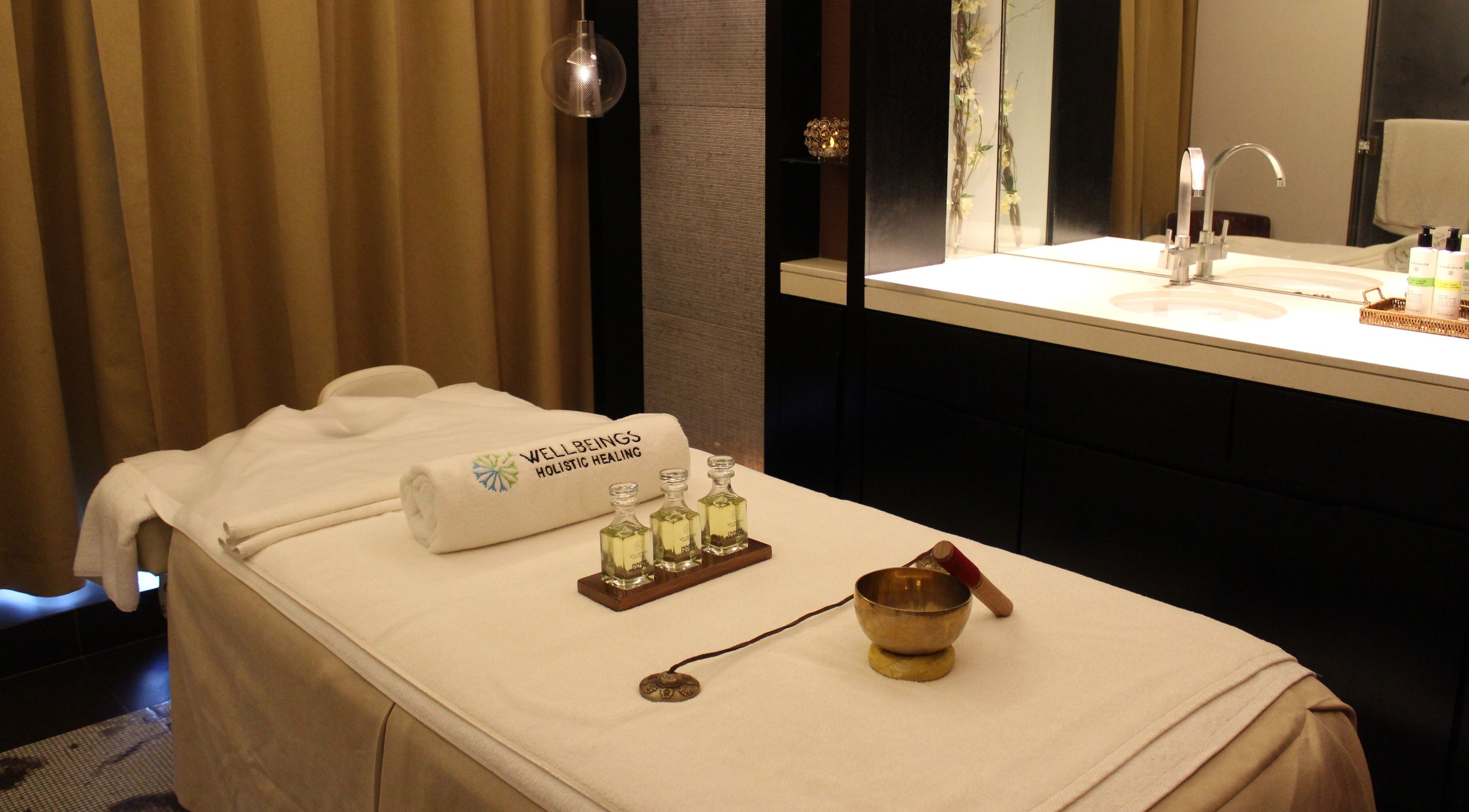 Relaxing massage room at Wellbeings Holistic Healing, Dubai, AE, featuring a treatment table and calming decor.