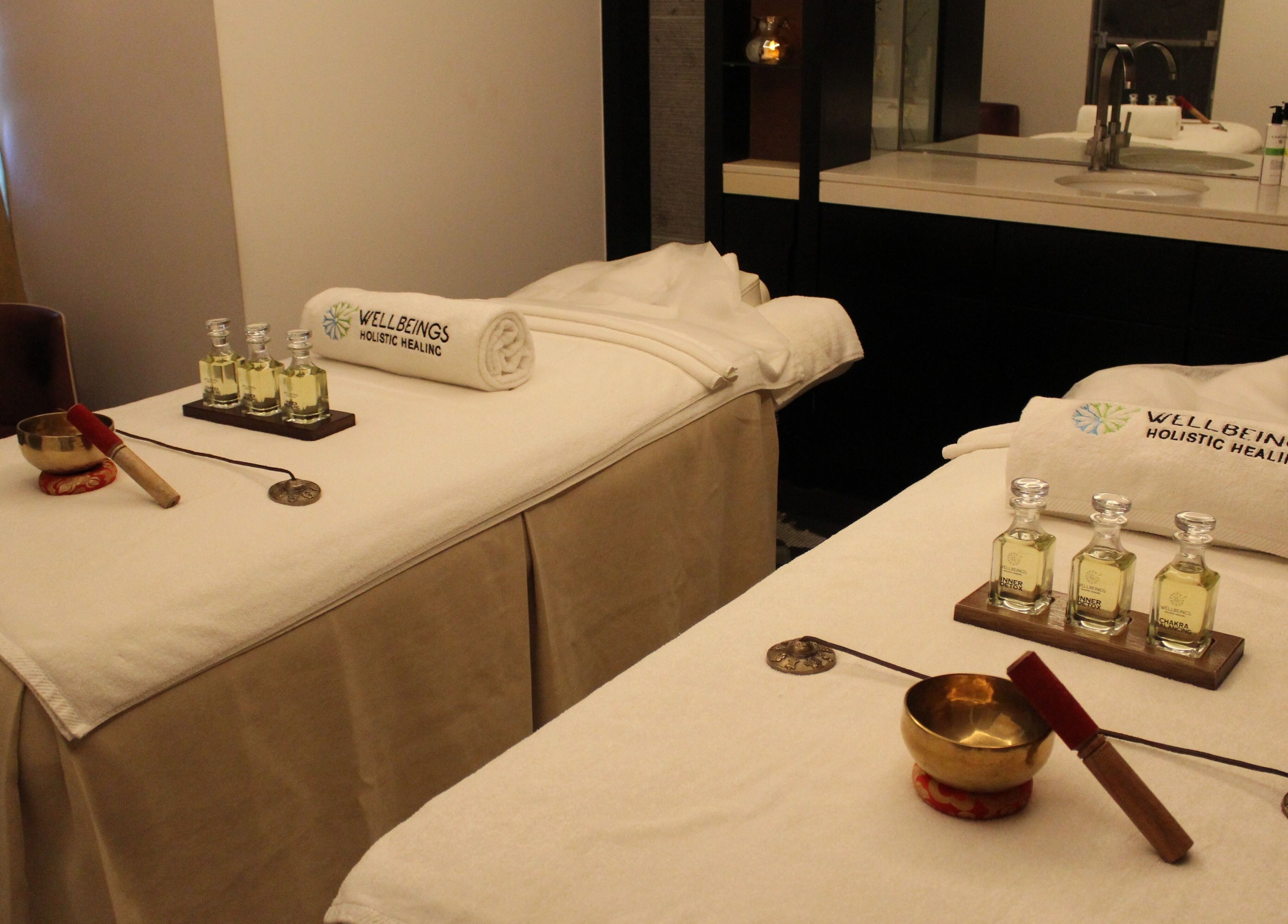 Tranquil treatment room at Wellbeings Holistic Healing, Dubai, AE, featuring massage tables and essential oils.