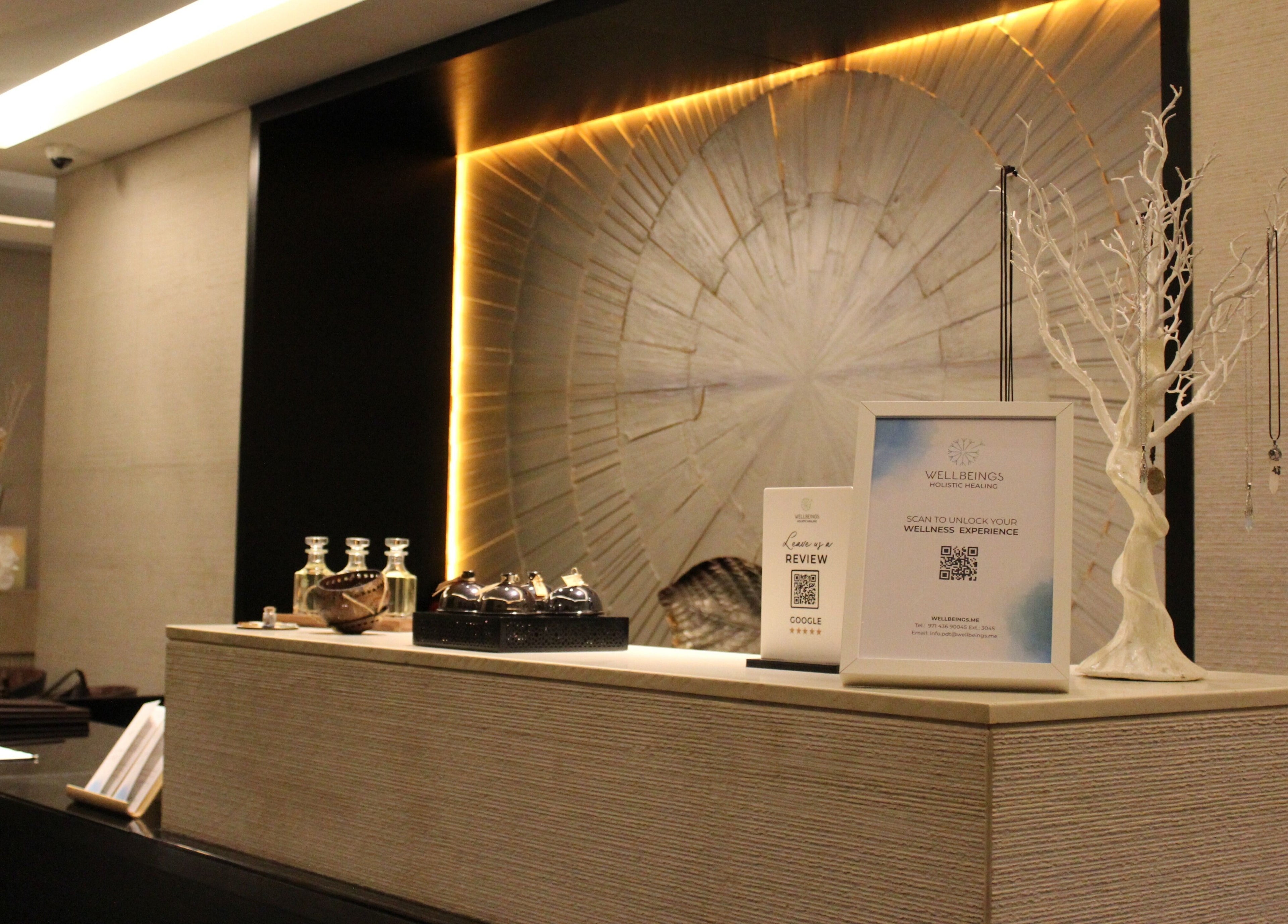 Reception desk at Wellbeings Holistic Healing in Dubai, AE with decor and wellness items displayed elegantly.