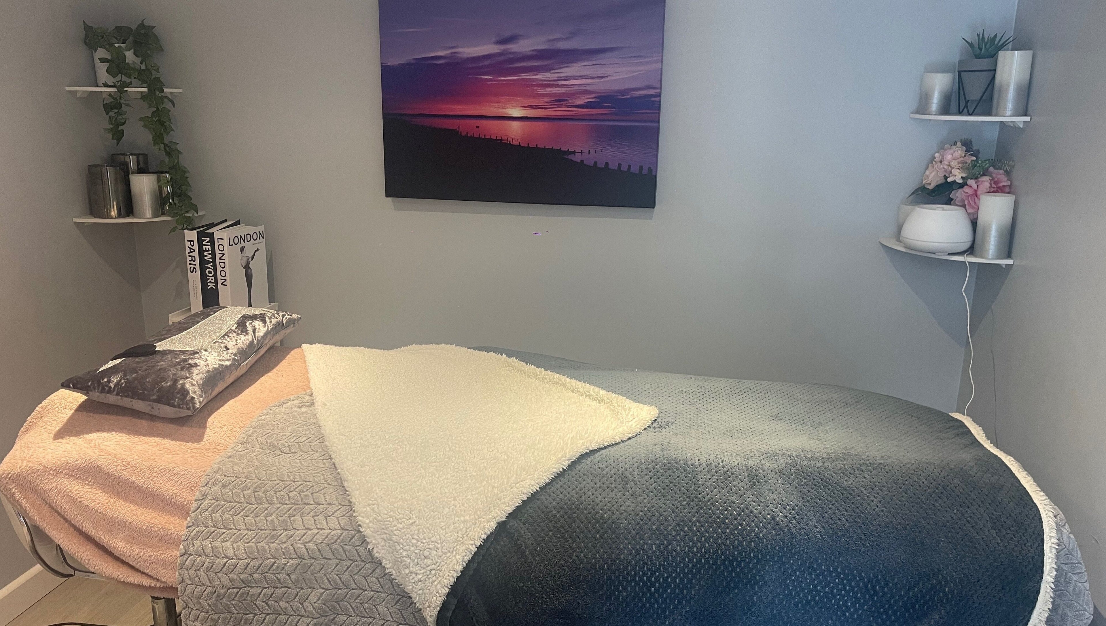 Relaxing therapy room at MedicAesthetics, Oakley, England, GB with cozy blankets and calming decor.