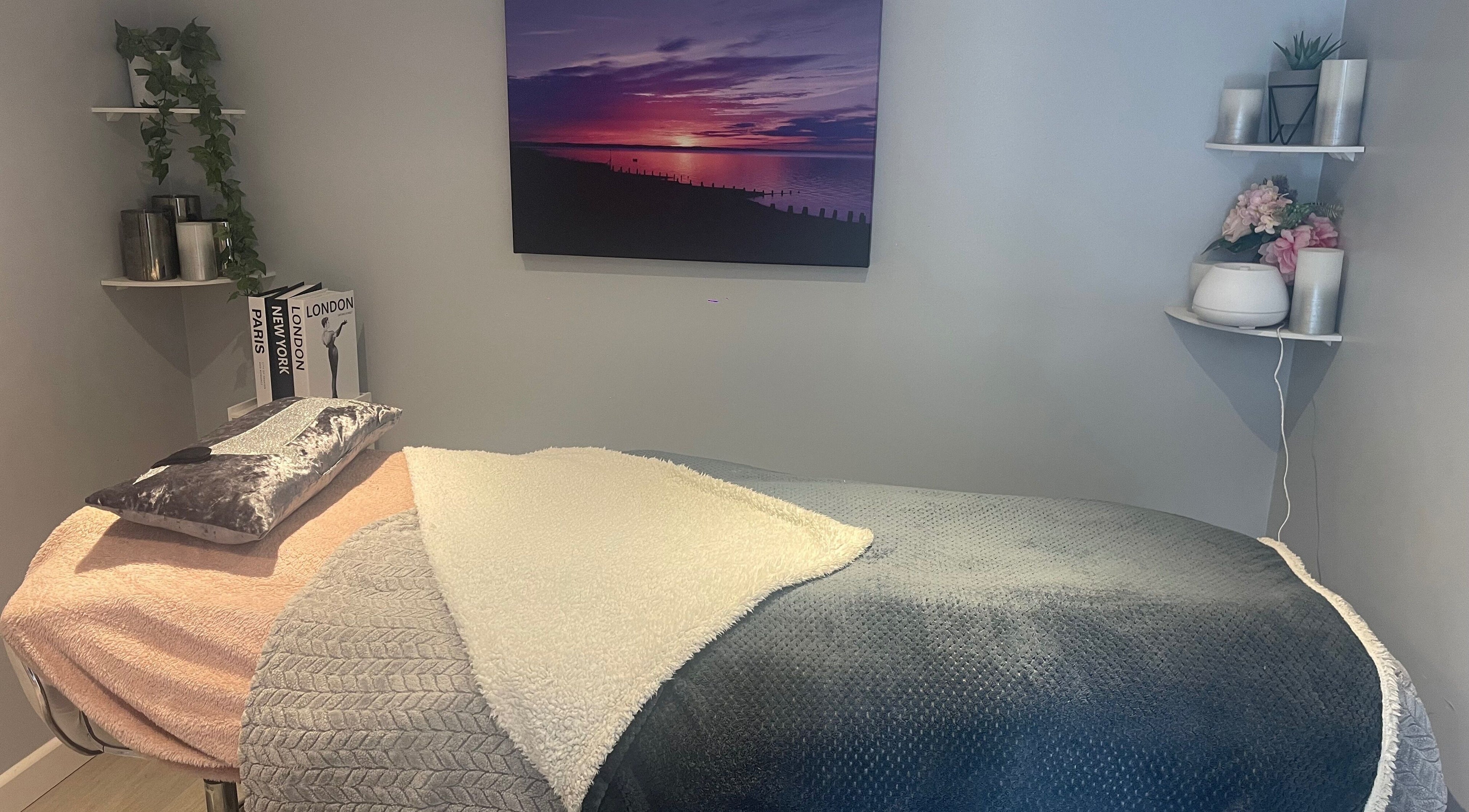 Relaxing therapy room at MedicAesthetics, Oakley, England, GB with cozy blankets and calming decor.