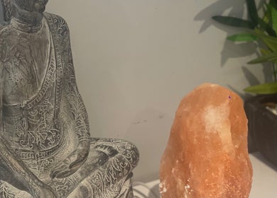 Buddha statue with Himalayan salt lamp at MedicAesthetics, Oakley, England, GB.