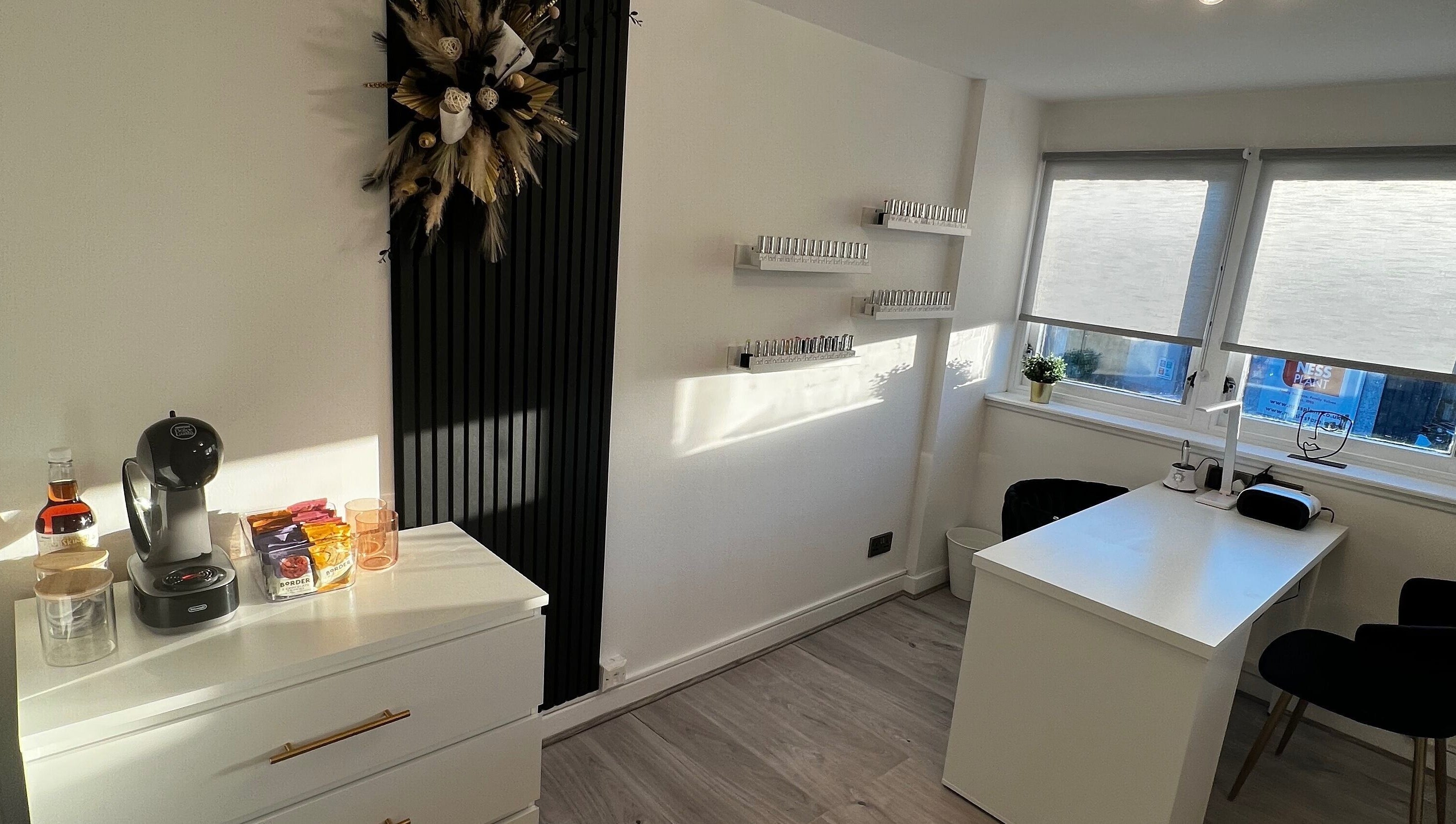 Bright manicure station at CM Nails & Beauty, Bridge Of Allan, Scotland, GB, with nail polish display and coffee setup.