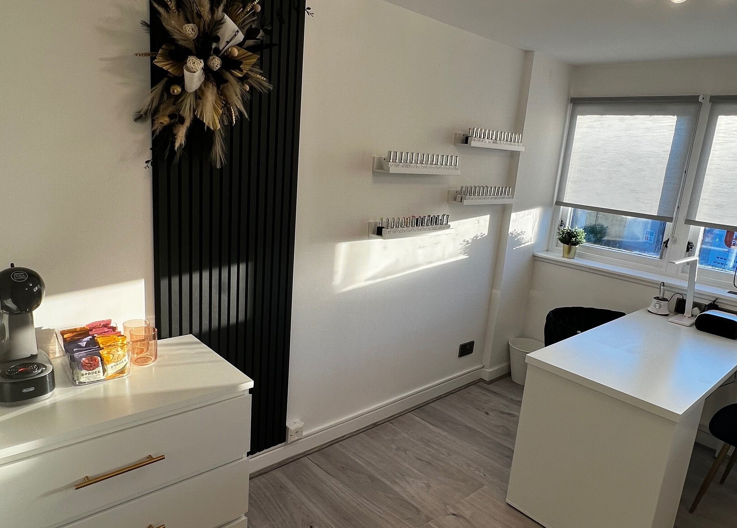 Bright manicure station at CM Nails & Beauty, Bridge Of Allan, Scotland, GB, with nail polish display and coffee setup.