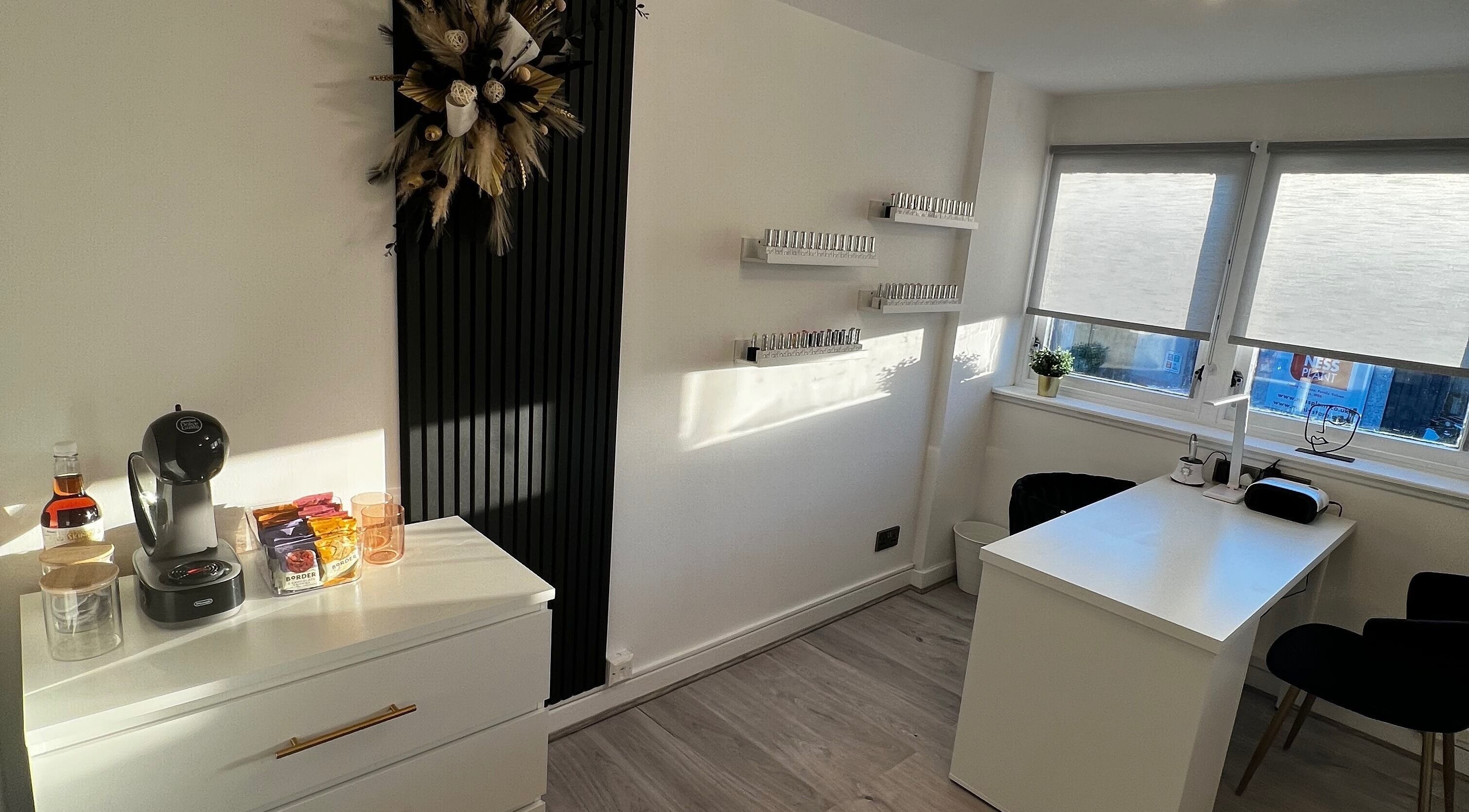 Bright manicure station at CM Nails & Beauty, Bridge Of Allan, Scotland, GB, with nail polish display and coffee setup.