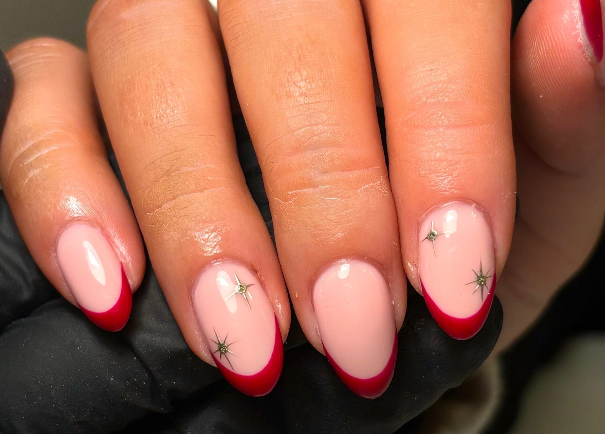Nail art with red tips and star accents at CM Nails & Beauty, Bridge Of Allan, Scotland, GB.