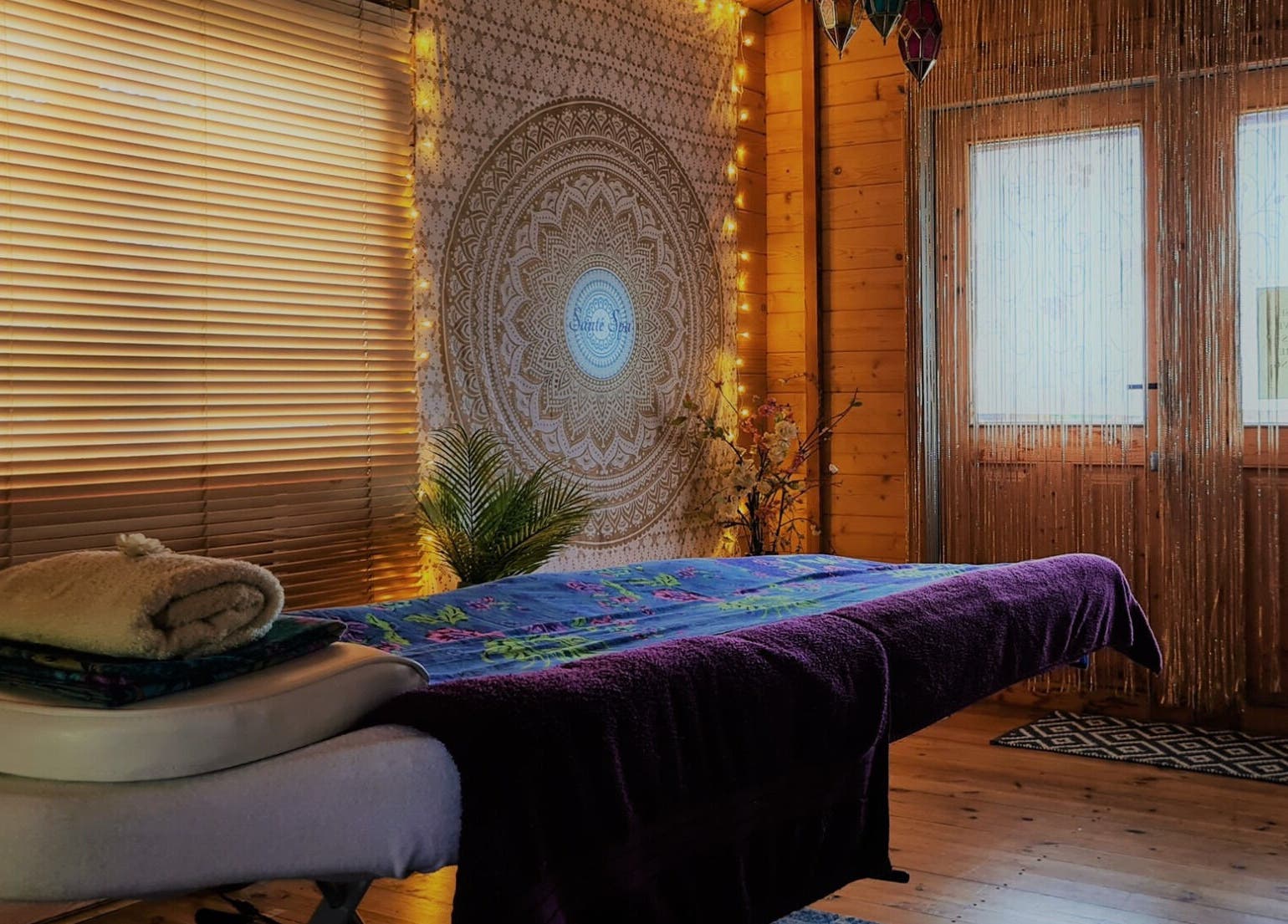 Peaceful massage room at Santé Spa Retreat, Sandiway, England, GB with ambient lighting and cozy decor.
