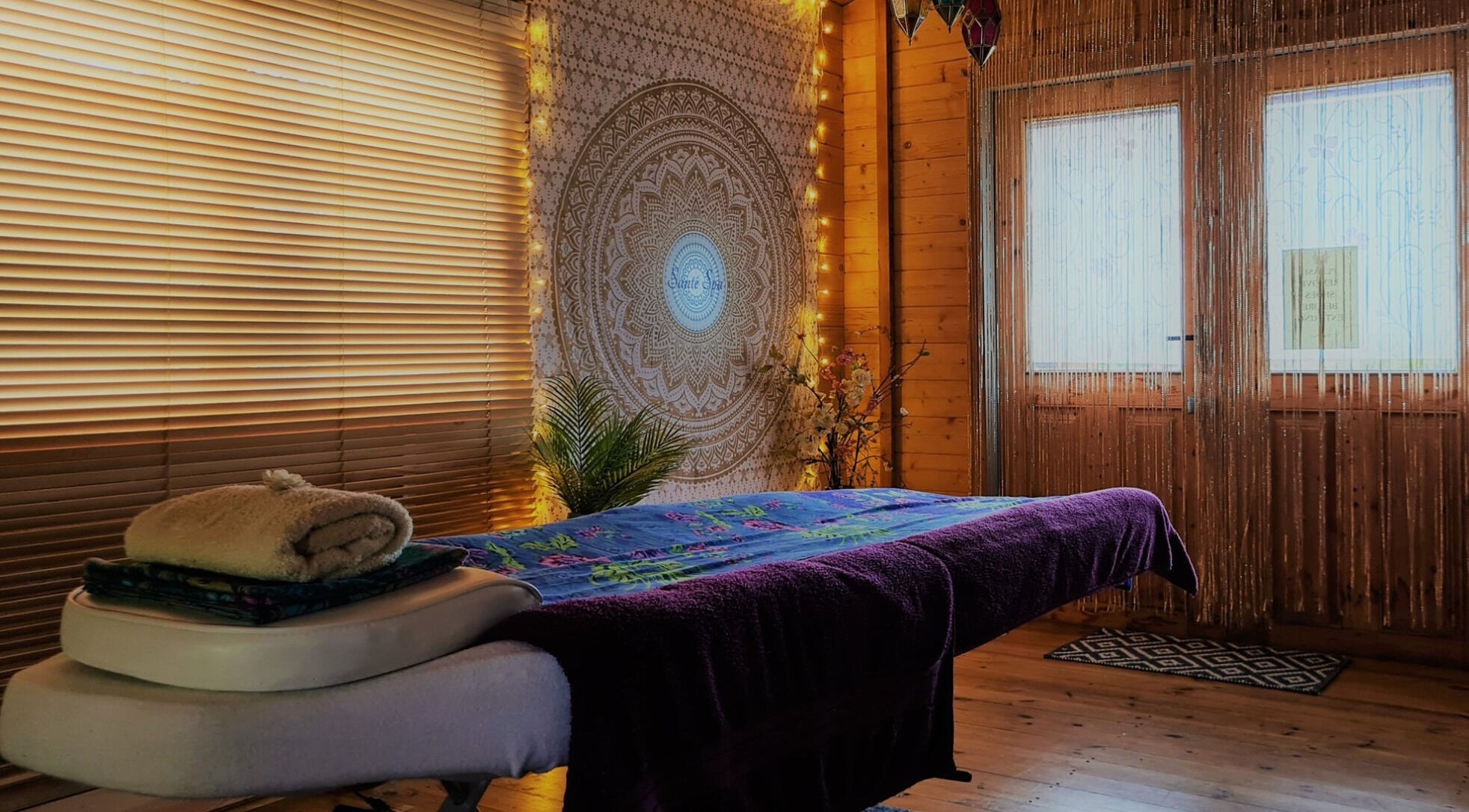 Peaceful massage room at Santé Spa Retreat, Sandiway, England, GB with ambient lighting and cozy decor.