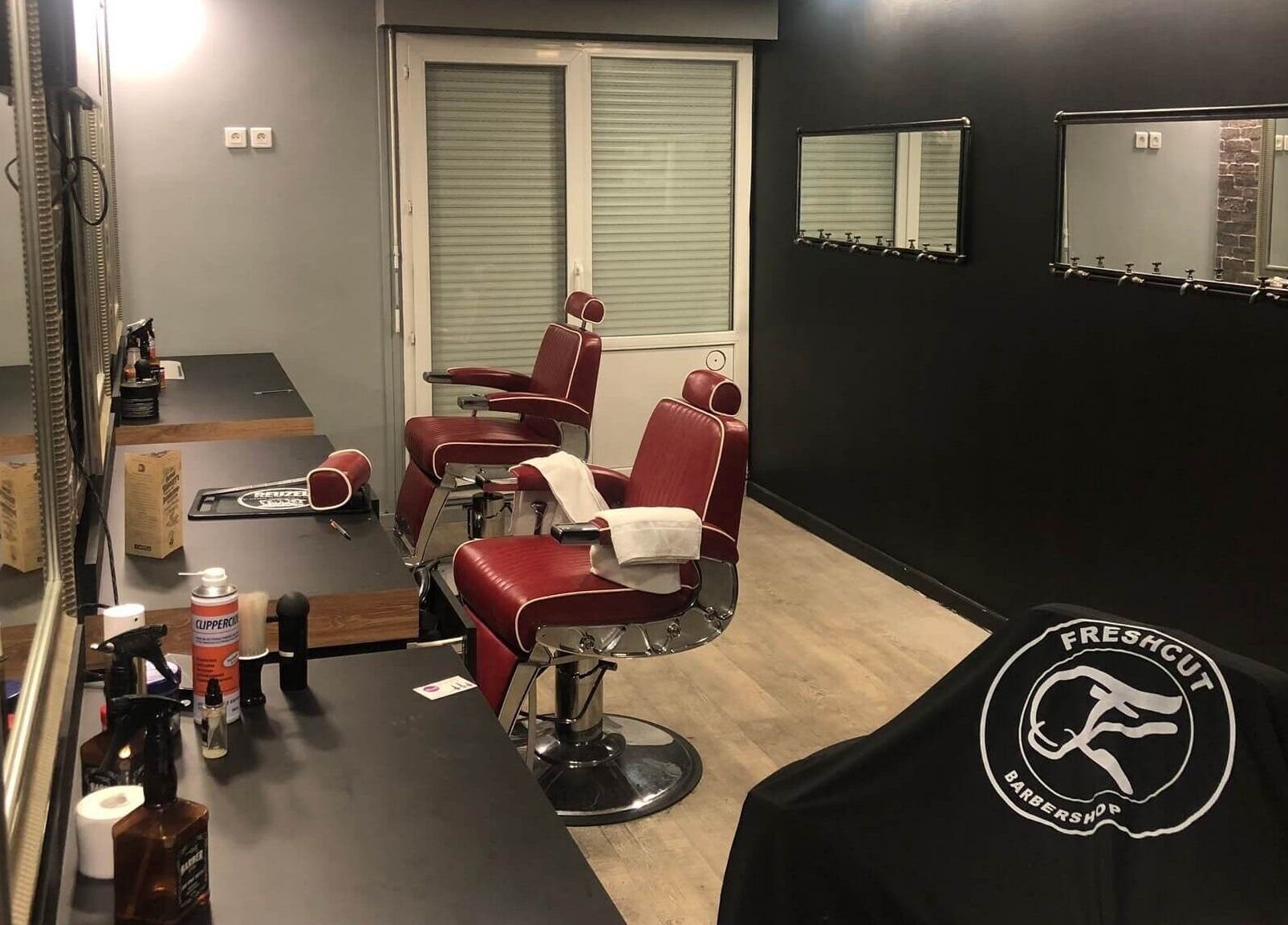 Intérieur moderne du salon Freshcut Épinay à Épinay-sous-Sénart, Île-de-France avec chaises coiffure rouges.