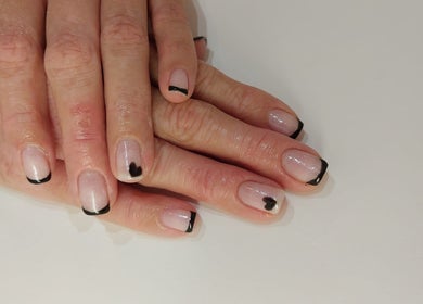 Elegant black tipped nails with heart design at Pink Beauty, Glasgow, Scotland, GB.