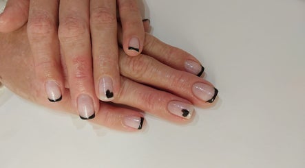 Elegant black tipped nails with heart design at Pink Beauty, Glasgow, Scotland, GB.