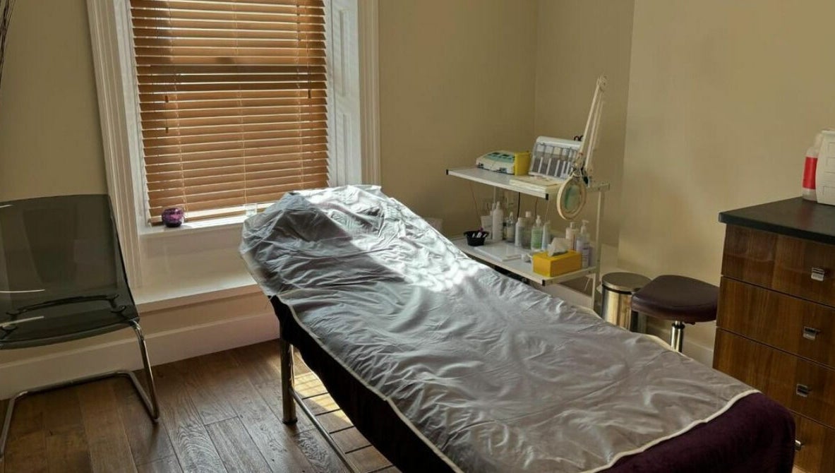 Relaxing treatment room at New Image, Bangor, Wales, GB with massage bed and calming decor.