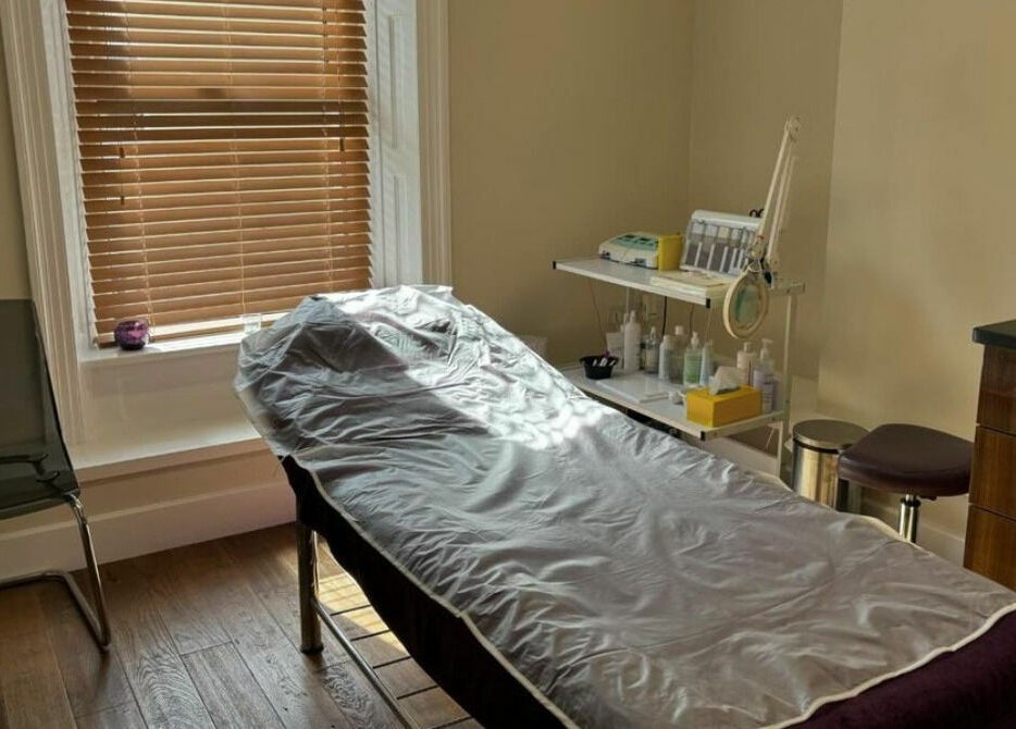 Relaxing treatment room at New Image, Bangor, Wales, GB with massage bed and calming decor.