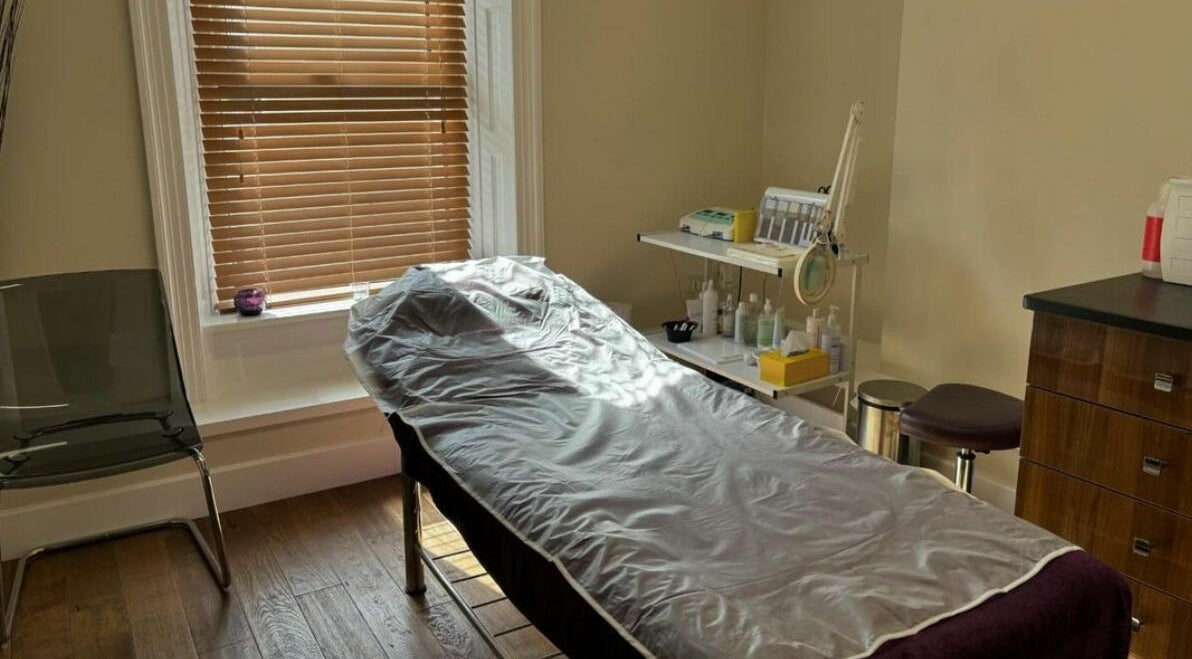 Relaxing treatment room at New Image, Bangor, Wales, GB with massage bed and calming decor.