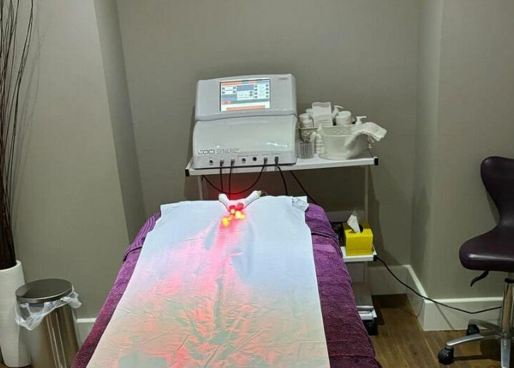 Modern treatment room at New Image, featuring a massage bed and equipment in Bangor, Wales, GB.