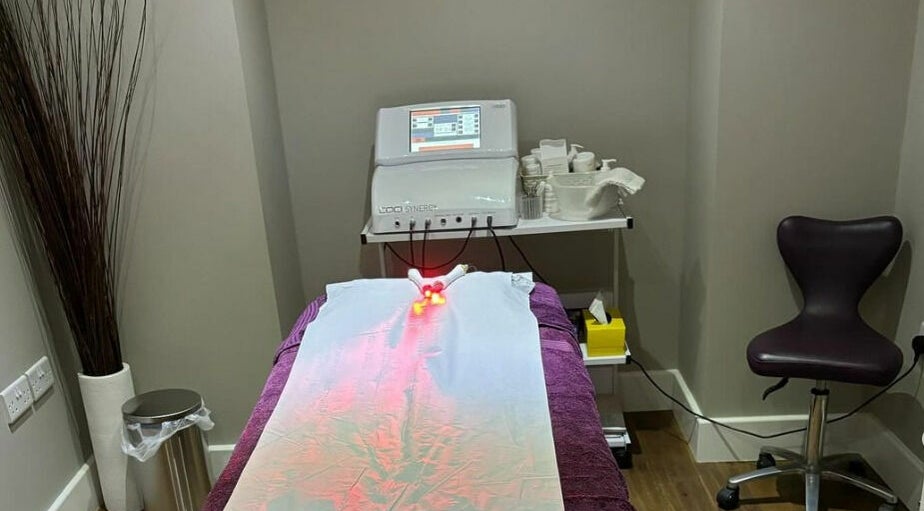 Modern treatment room at New Image, featuring a massage bed and equipment in Bangor, Wales, GB.