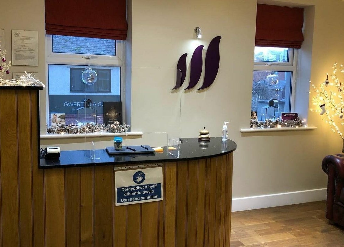 Reception area at New Image, Bangor, Wales, GB with festive decor and cozy seating.