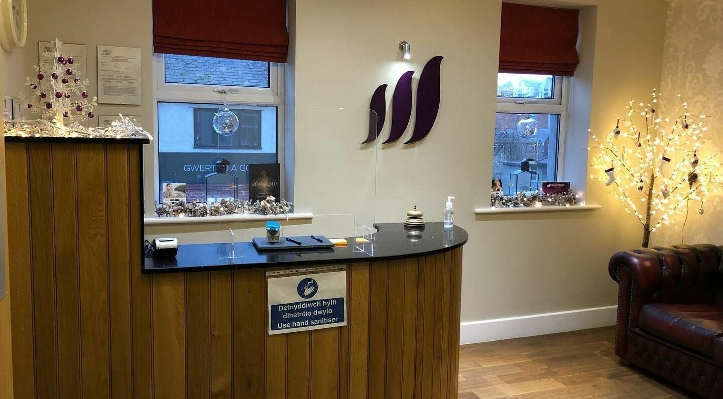 Reception area at New Image, Bangor, Wales, GB with festive decor and cozy seating.